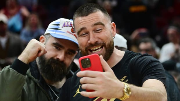 Mar 5, 2024; Cleveland, Ohio, USA; Cleveland natives and NFL players Travis, right, and Jason Kelce celebrate after the Cleveland Cavaliers beat the Boston Celtics during the second half at Rocket Mortgage FieldHouse.